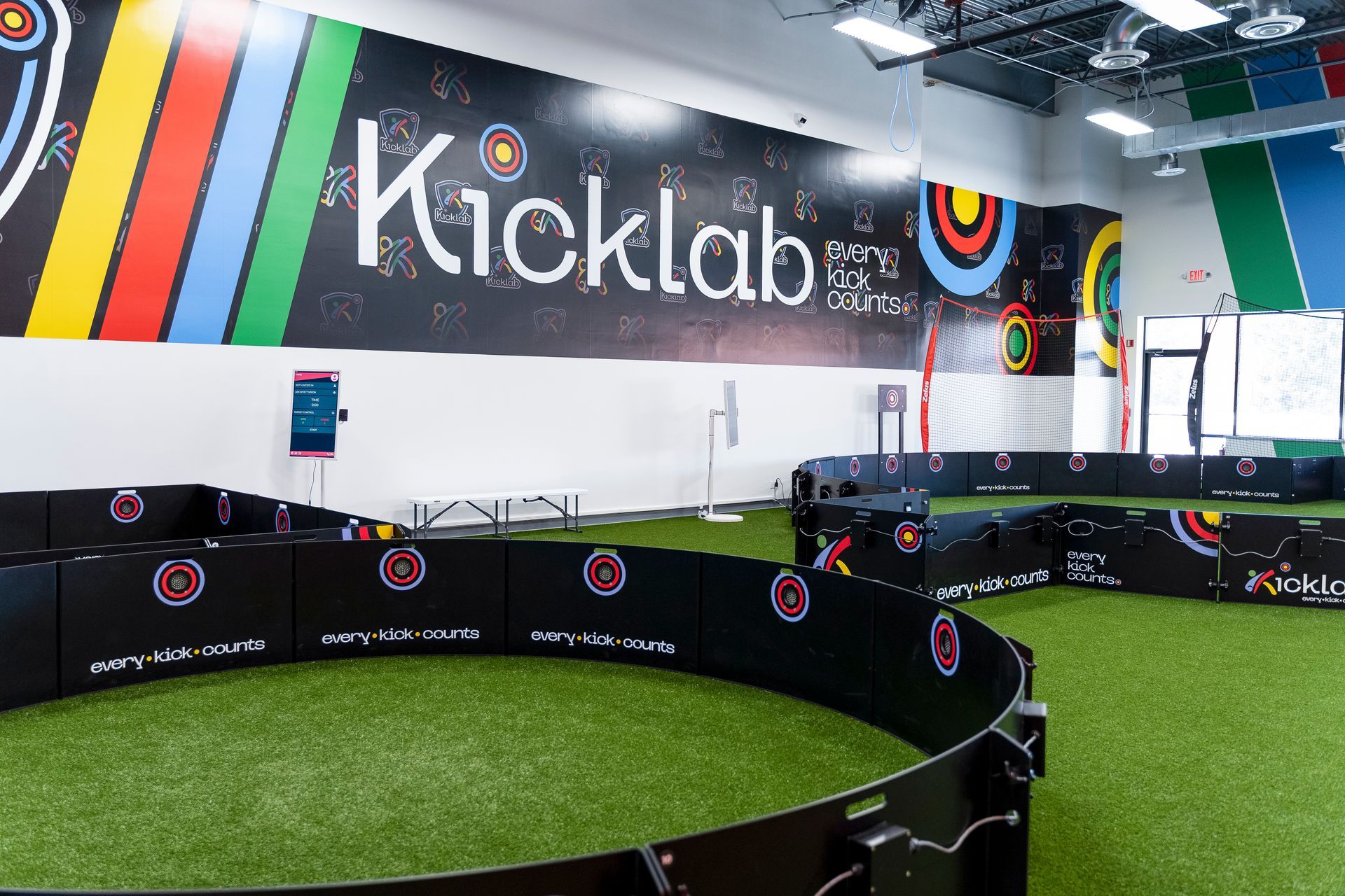 A large sign on the wall of a building says kicklab.