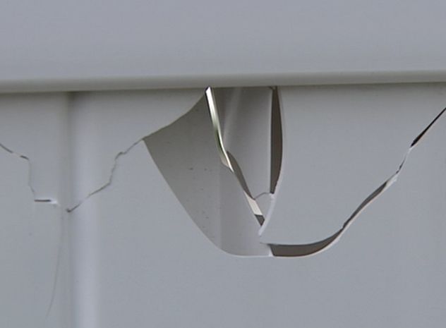 Damaged White Vinyl Fence