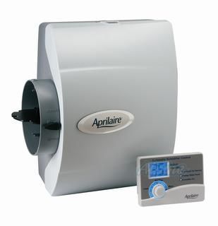 Aprilaire whole-house humidifier with digital control panel, gray housing, and duct connection.