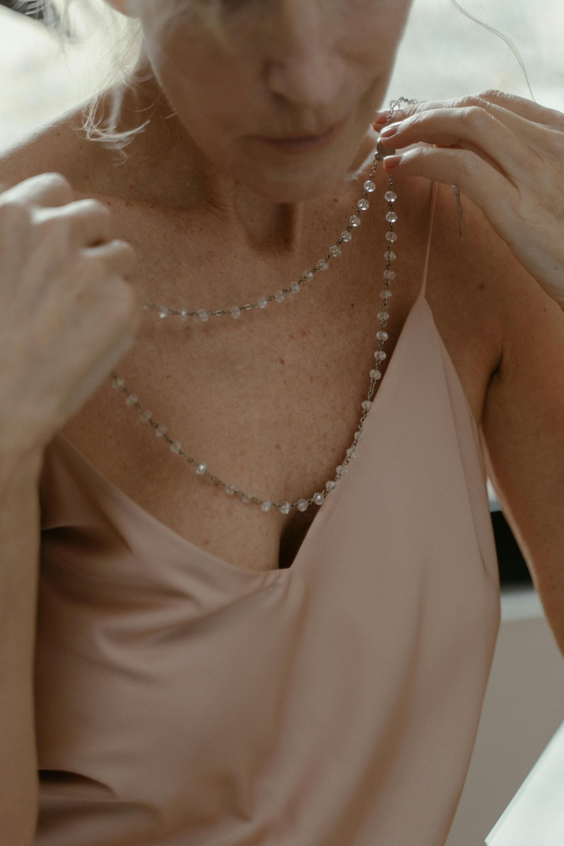 Person applying foundation to chest, concealing scars and blemishes with a dropper.