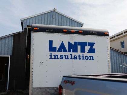 a white truck with the word lantz insulation on it