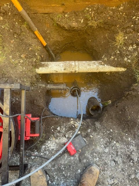 A person is digging a hole in the ground with a shovel.