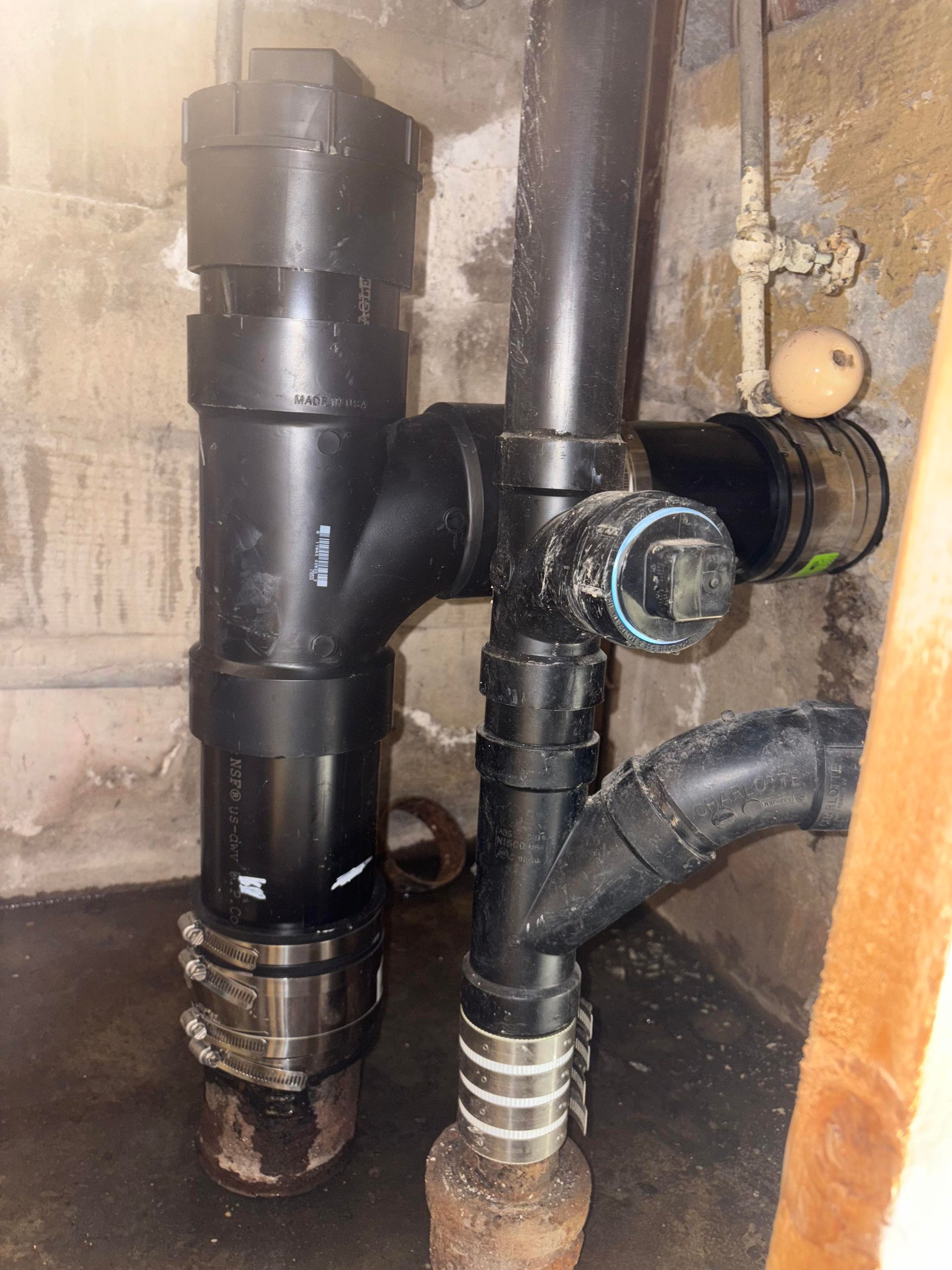 A bunch of black pipes are connected to each other in a room.