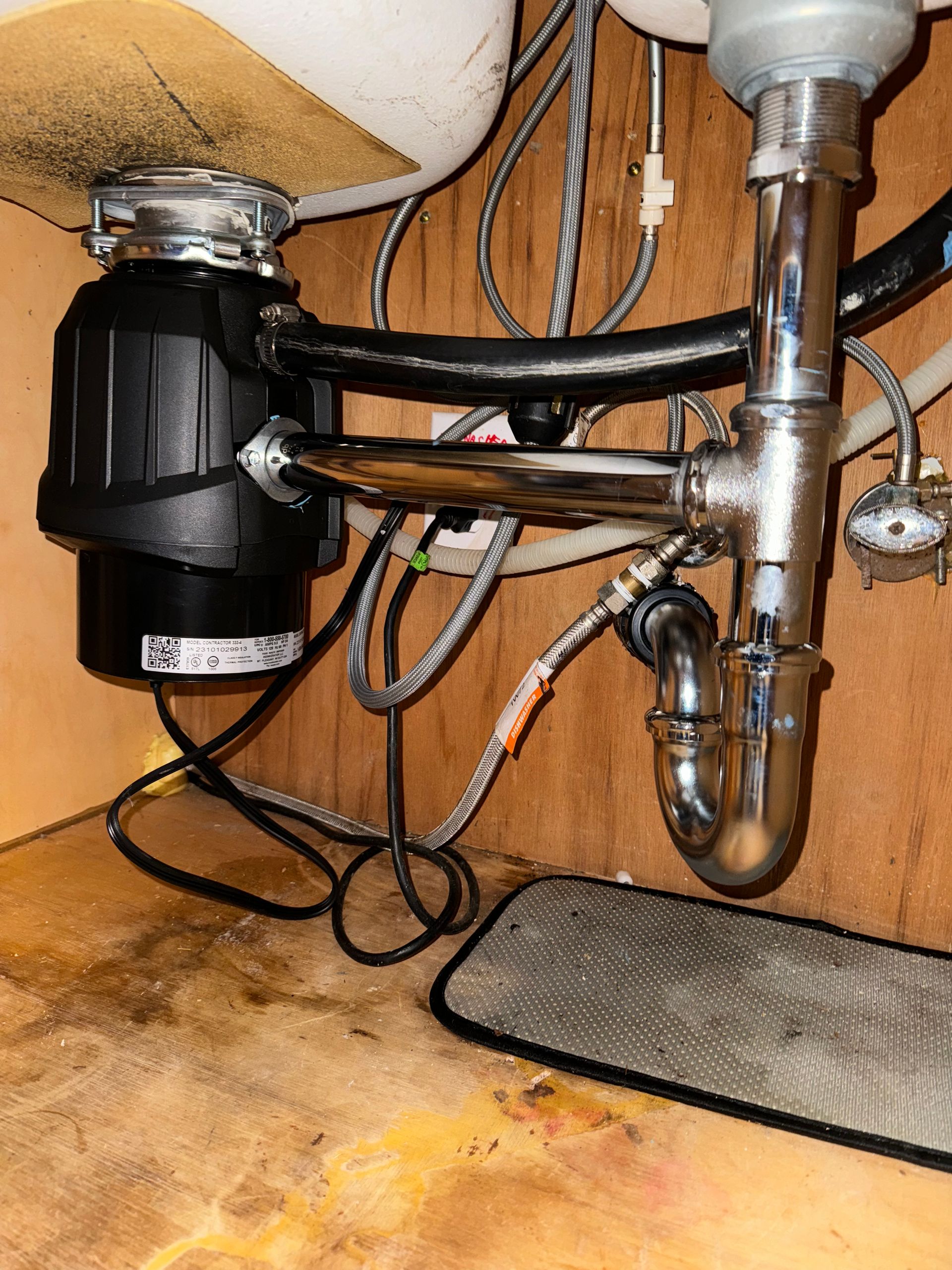 A sink with a garbage disposal underneath it