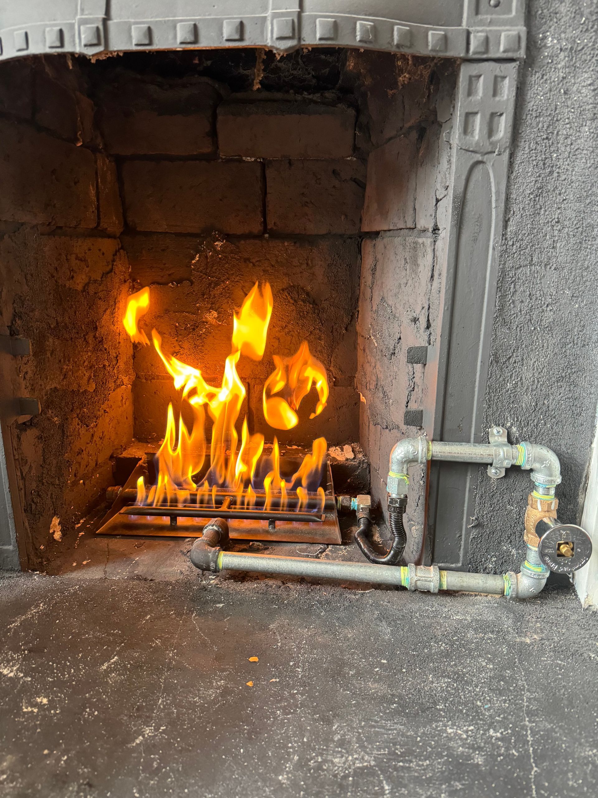 A fireplace with a lot of flames coming out of it