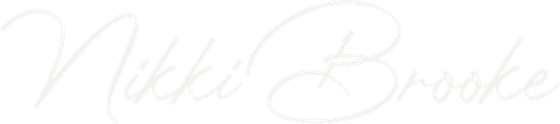 Light gray script logo reading “Nikki Brooke” on a white background