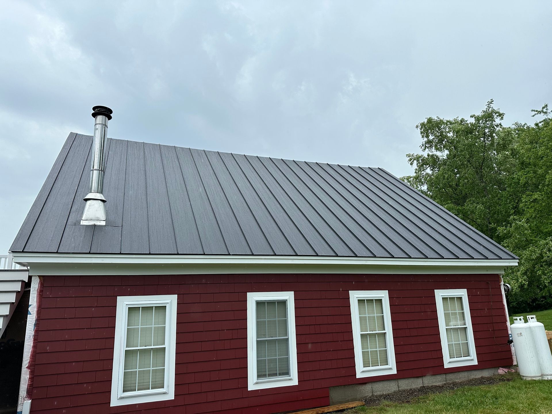 Damaged wooden floor with a square hole exposing dark interior. Boards are splintered and weathered.