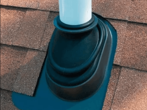 Black plumbing vent boot flashing on a brown shingled roof.