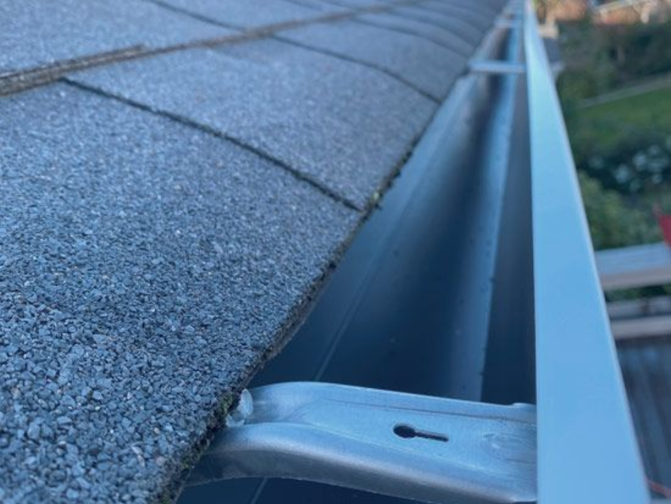 Ceiling with open skylight and ceiling fan; cloudy sky visible.