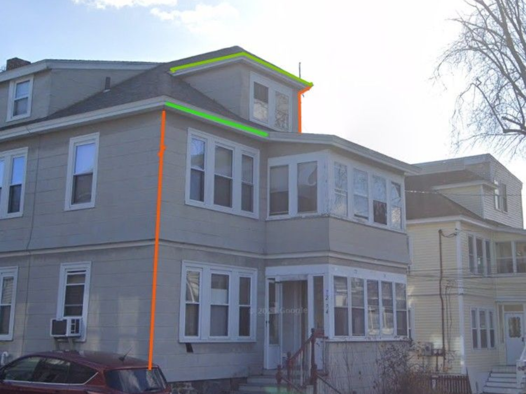 Skylight on a rooftop being measured with a yellow tape measure.