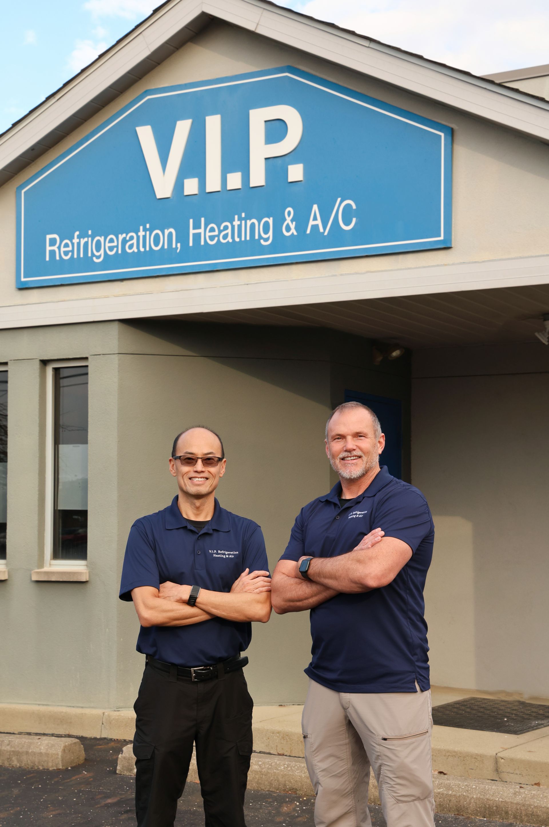Construction worker in blue overalls and hardhat installing a ceiling vent. Construction worker in blue overalls and hardhat installing a ceiling vent.