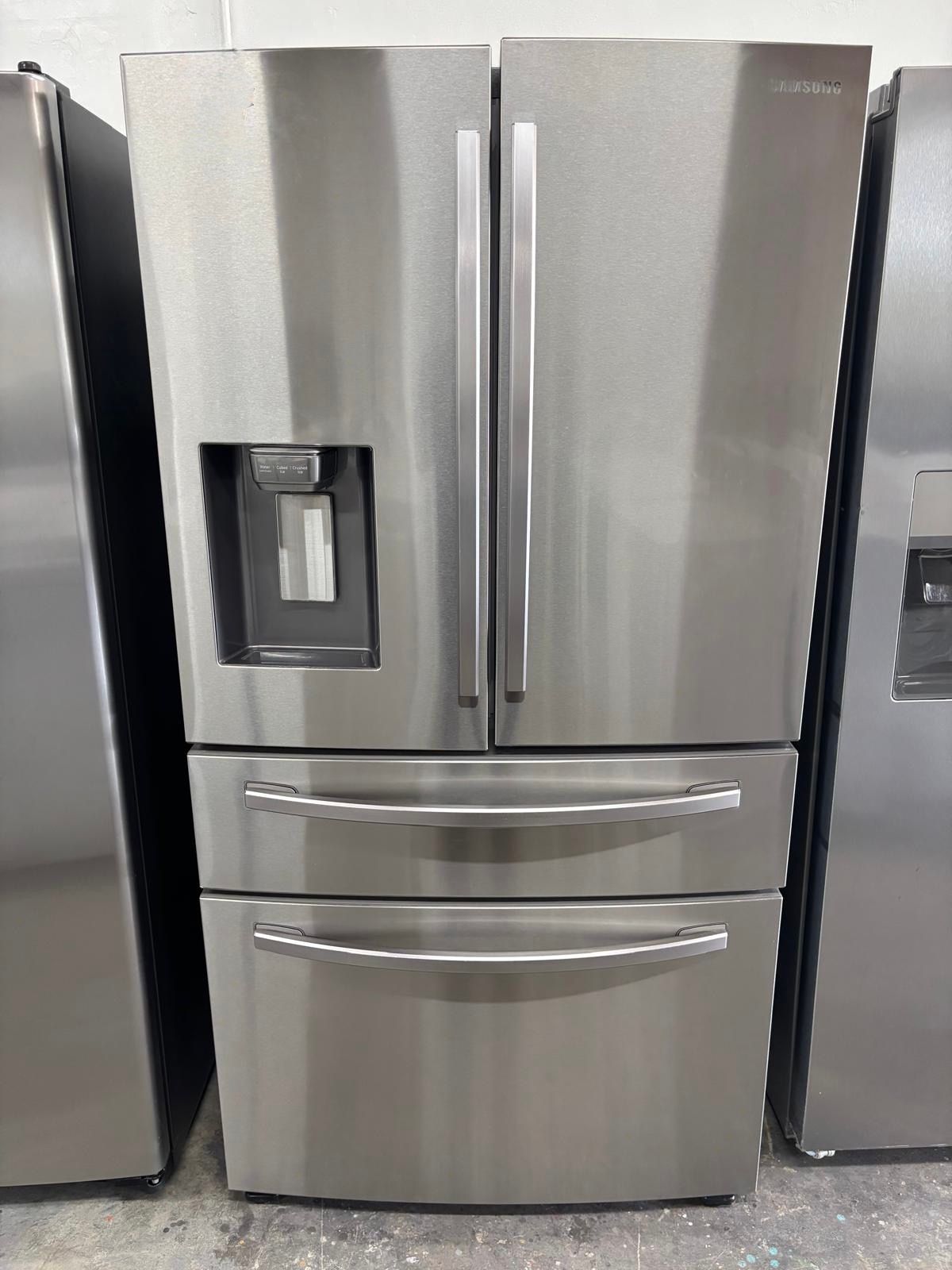 Stainless steel French door refrigerator with water dispenser on the left door and bottom freezer drawers.