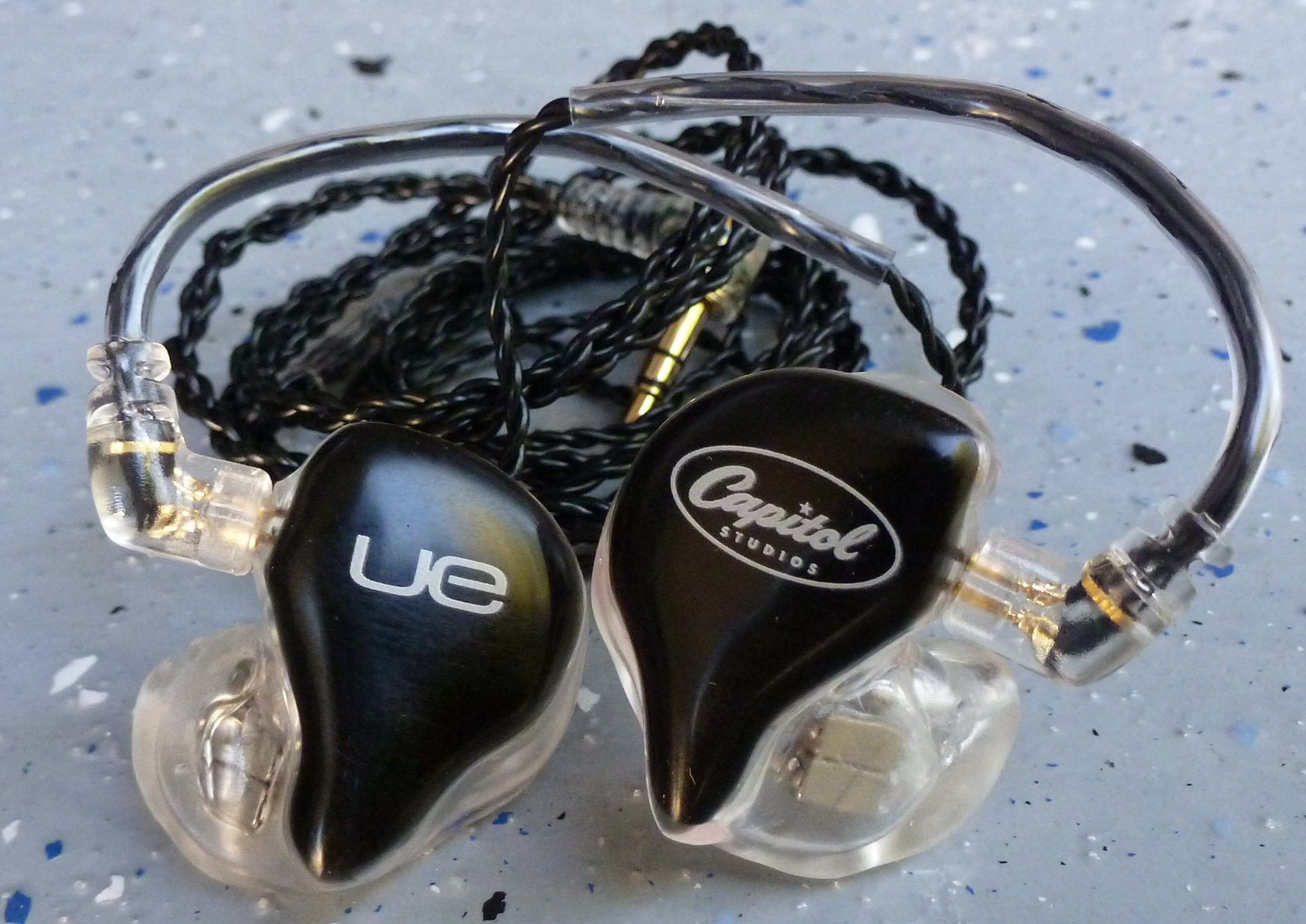 Two black and clear in-ear monitors with