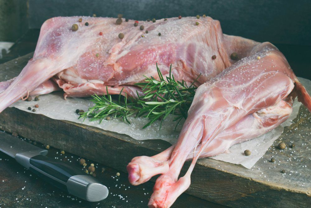 Whole Raw Lamb and Knife on the Wooden Board — Byron Bay Pork & Meats Butchery in Mullumbimby, NSW