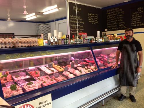 Butcher Standing Beside The Meat Display — Byron Bay Pork & Meats Butchery in Byron Bay, NSW