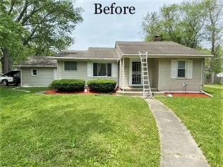 A before picture of a house with a ladder in front of it.