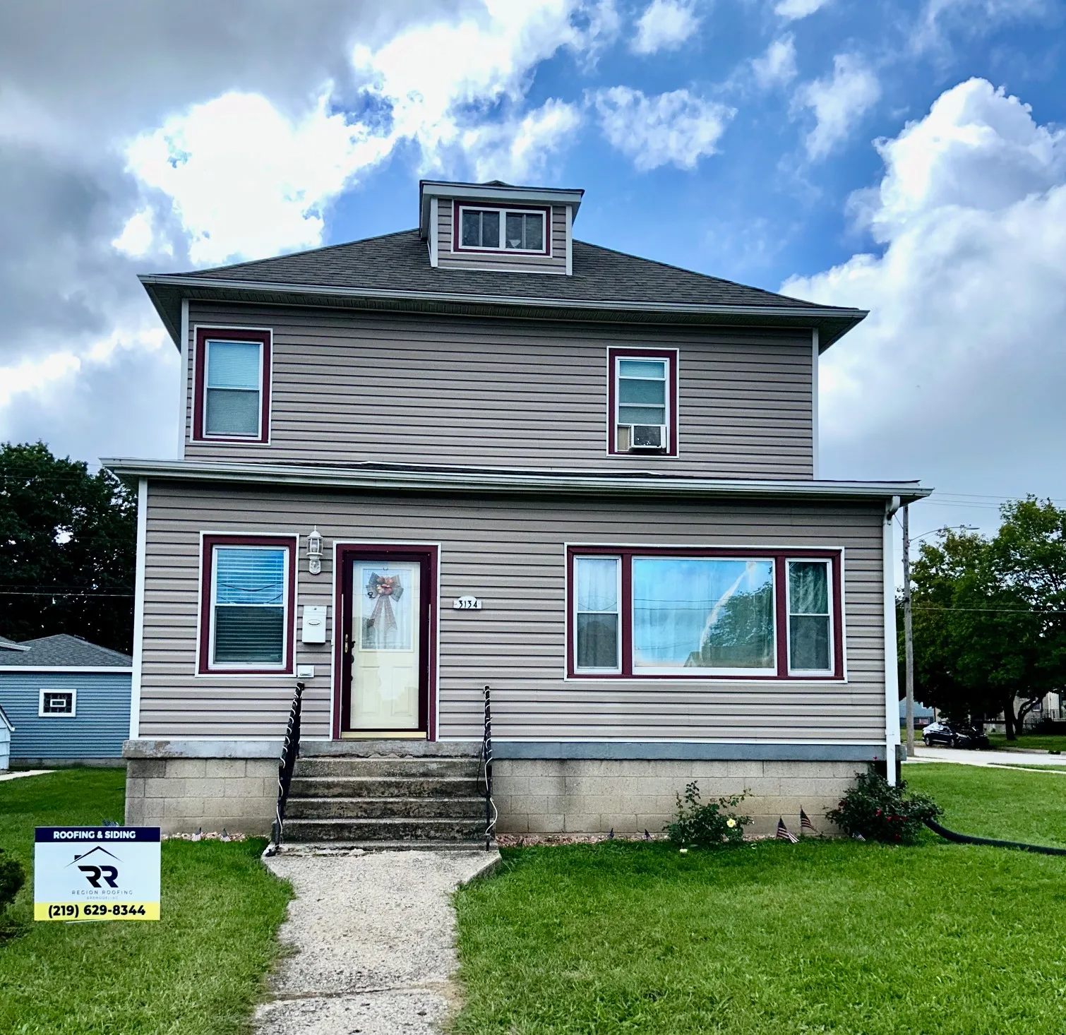 A house with a for sale sign in front of it