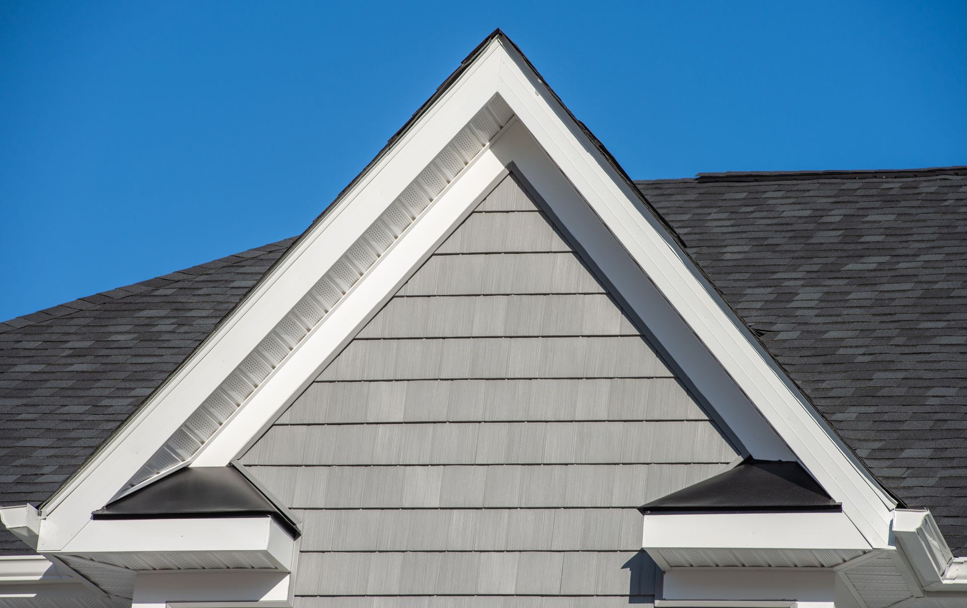 The roof of a house with a triangle shaped roof