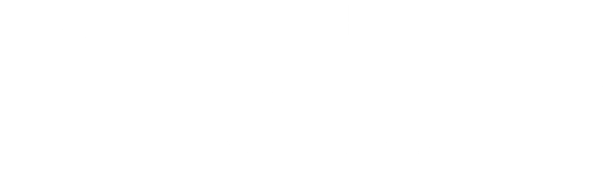 A person standing outdoors, holding a long, narrow wooden board near a stone wall.