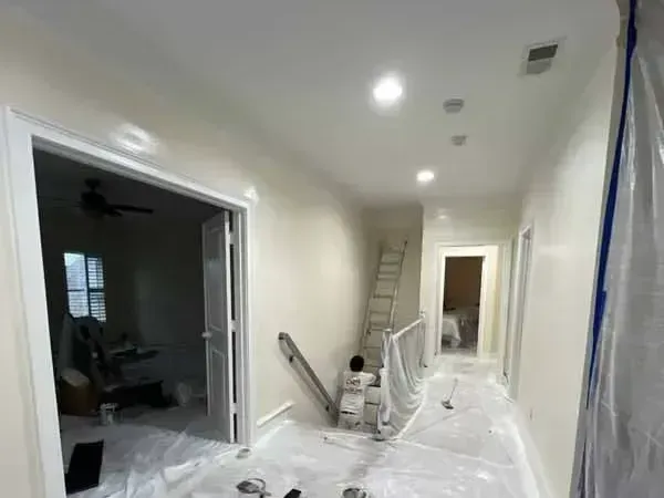 A living room with orange walls and a white couch.