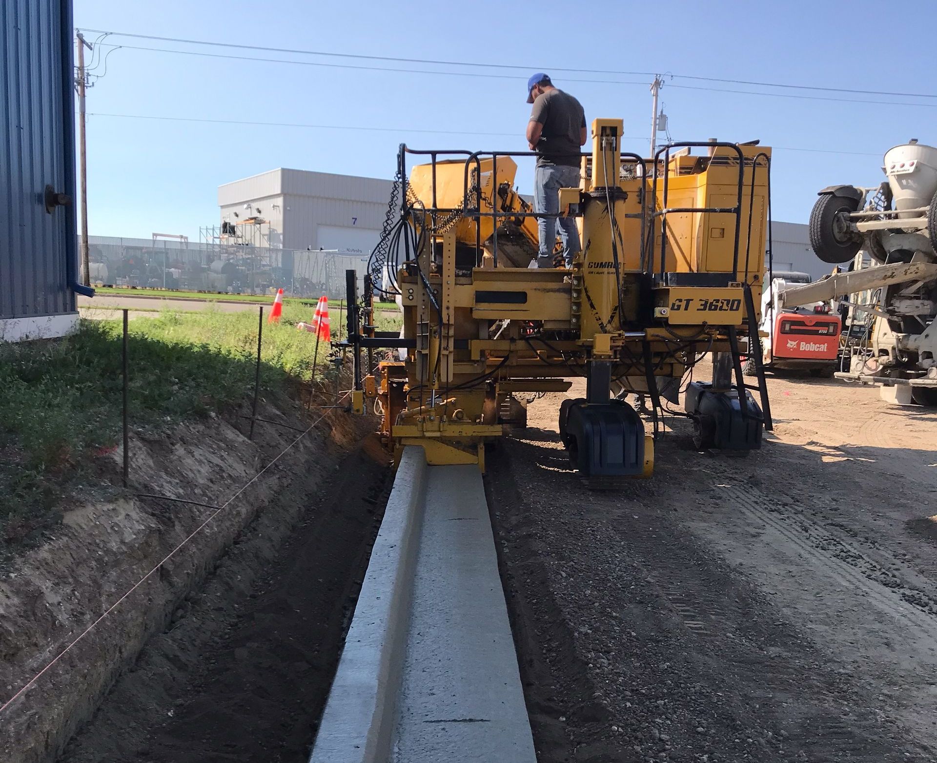 A man stands on top of a yellow machine that says gt 4200