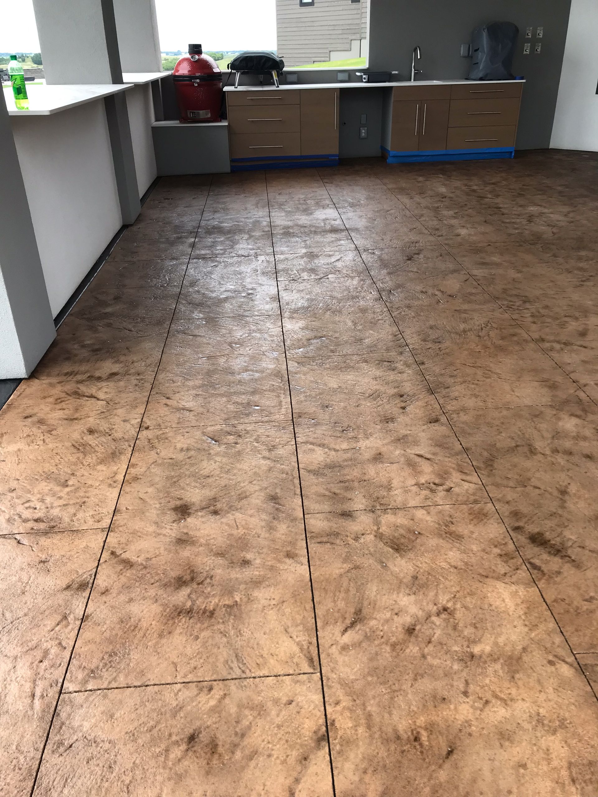A kitchen with a concrete floor and a counter top.