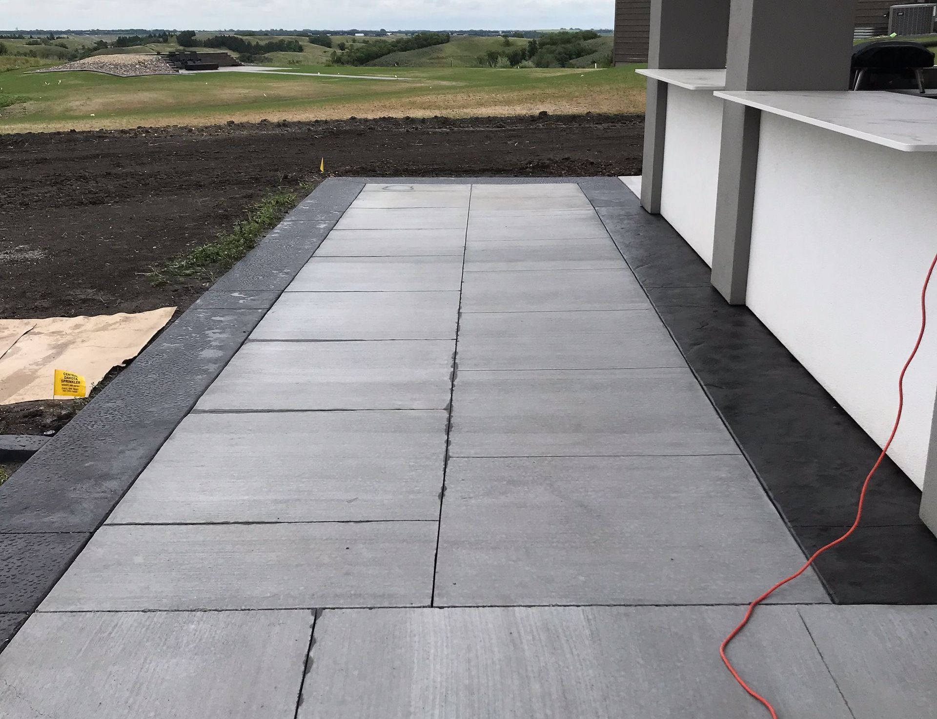 A patio with a view of a golf course is being built