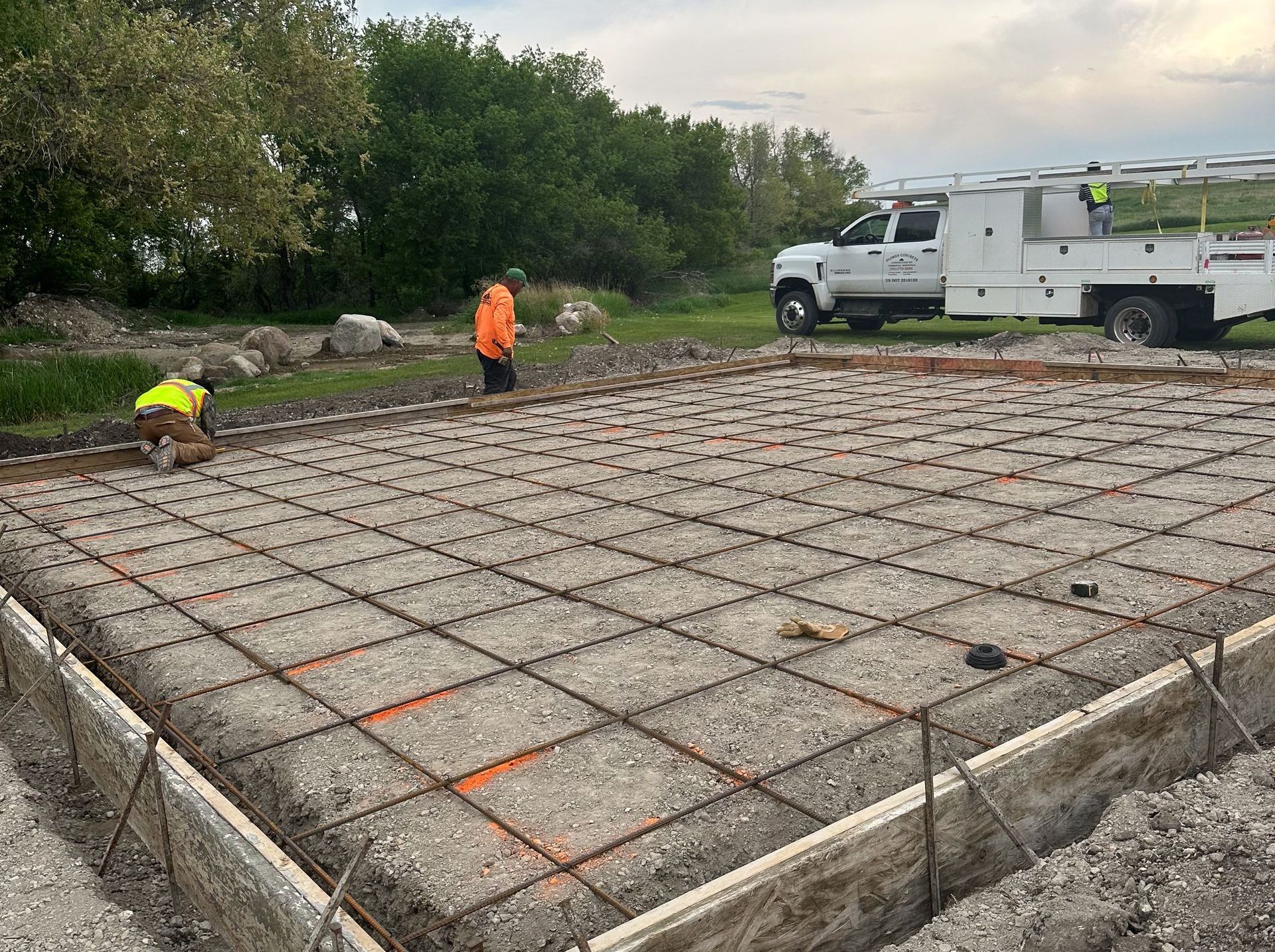 A concrete foundation is being built for a house.