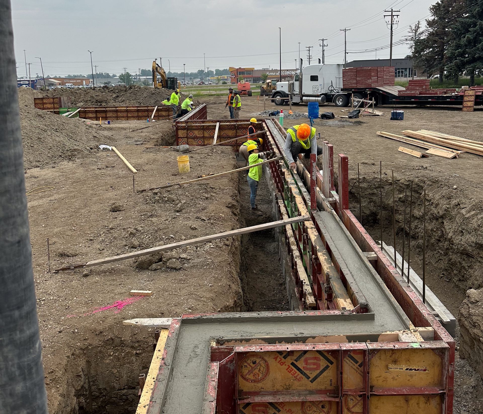 A concrete foundation for a house is being built.