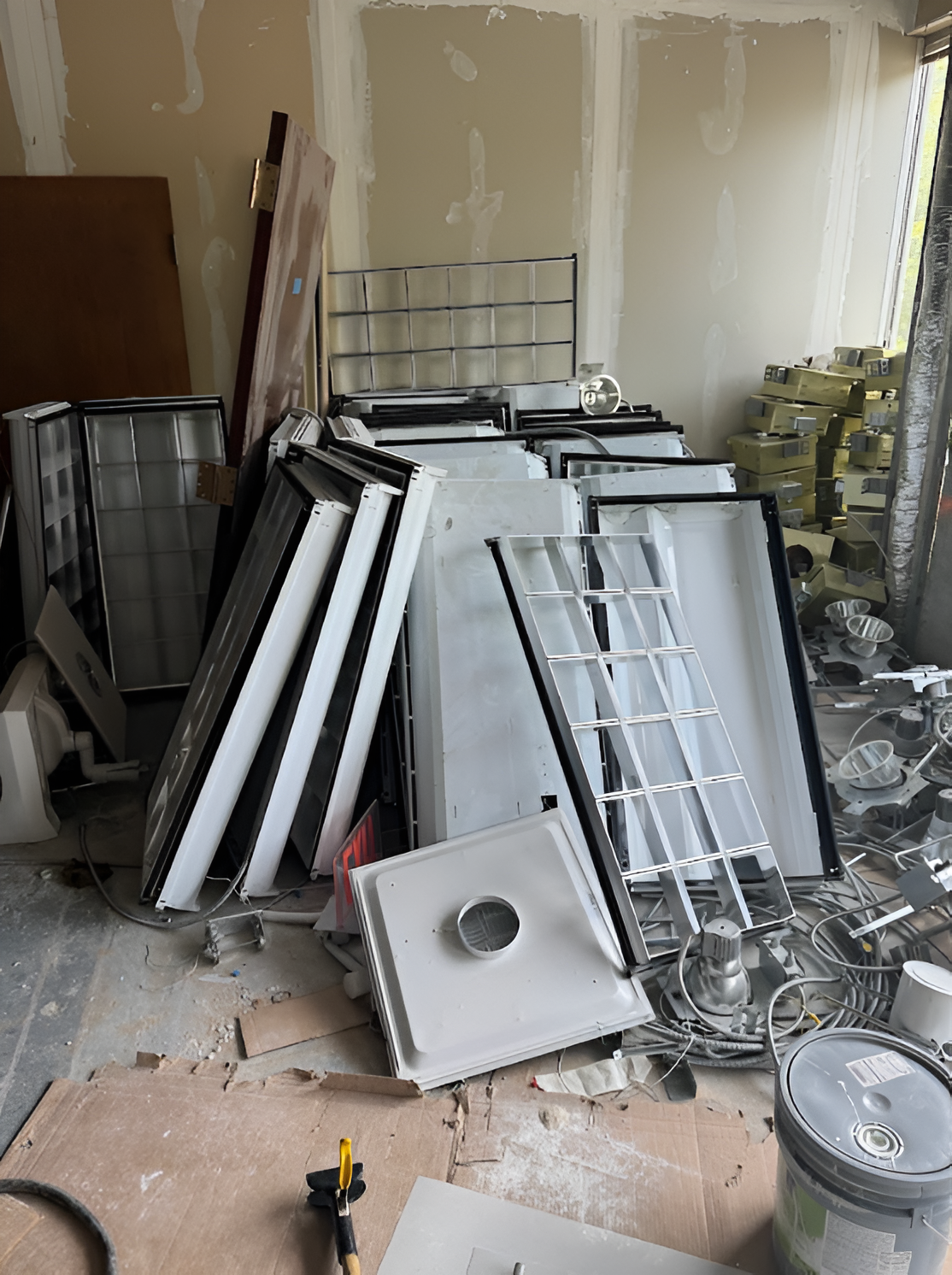 A room filled with a large pile of cardboard boxes, suggesting an unpacking or storage area.