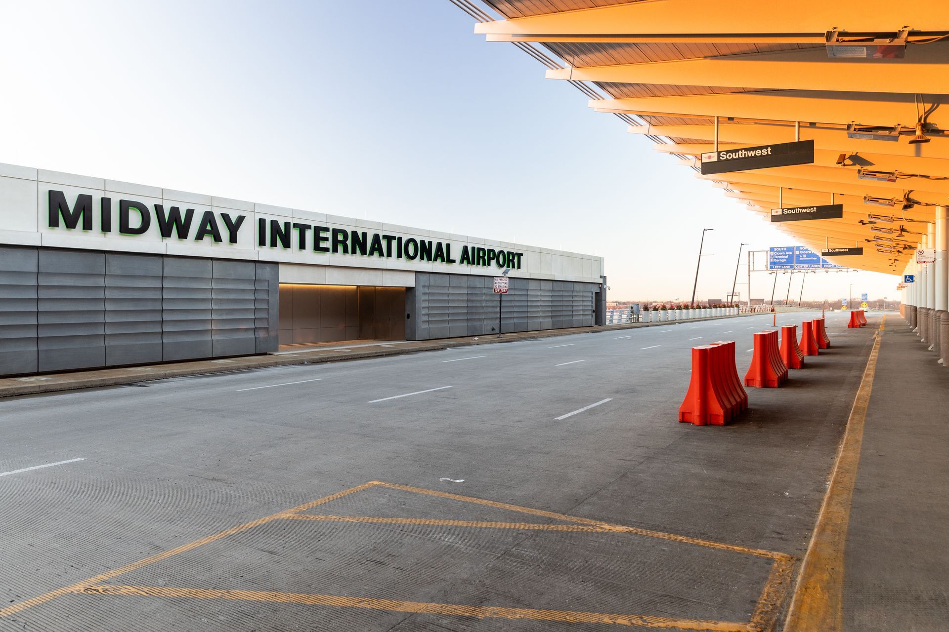 The exterior of the Midway International Airport sign at the departures during sunset.