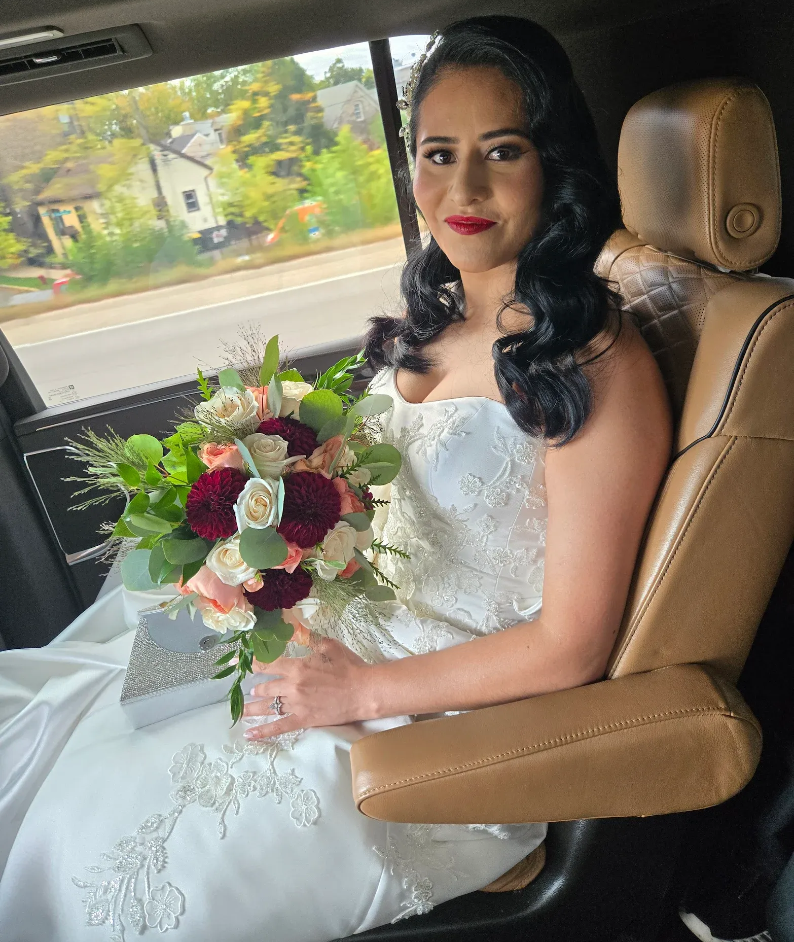 Bride sitting inside a Cadillac Escalade on her wedding day holding a bouquet — M.R. Black Car Service wedding transportation in Chicago.