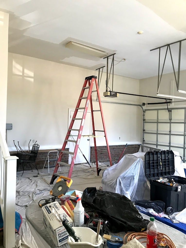 There is a ladder in the middle of the garage.