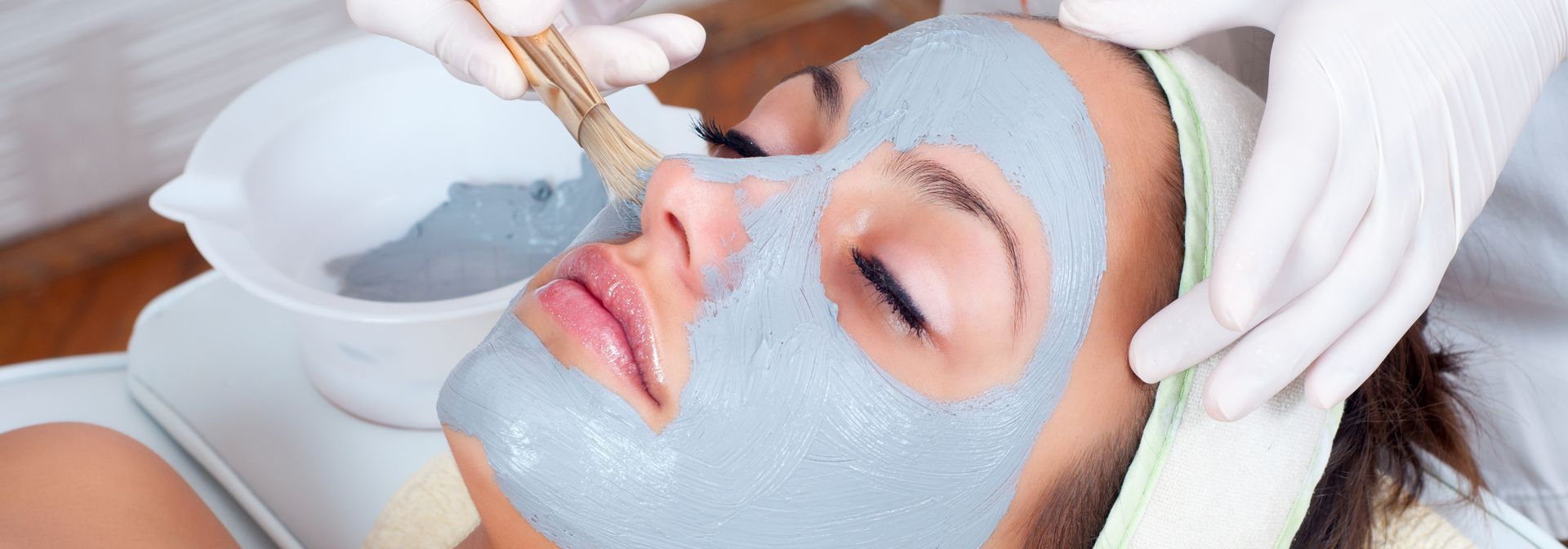  A woman with radiant skin relaxing while receiving a professional chemical peel at the luxurious Mo