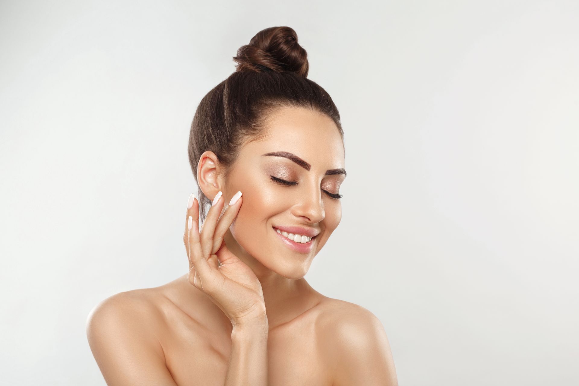 A woman with radiant, clear skin smiling after receiving a PRF treatment at our Miami medical spa.