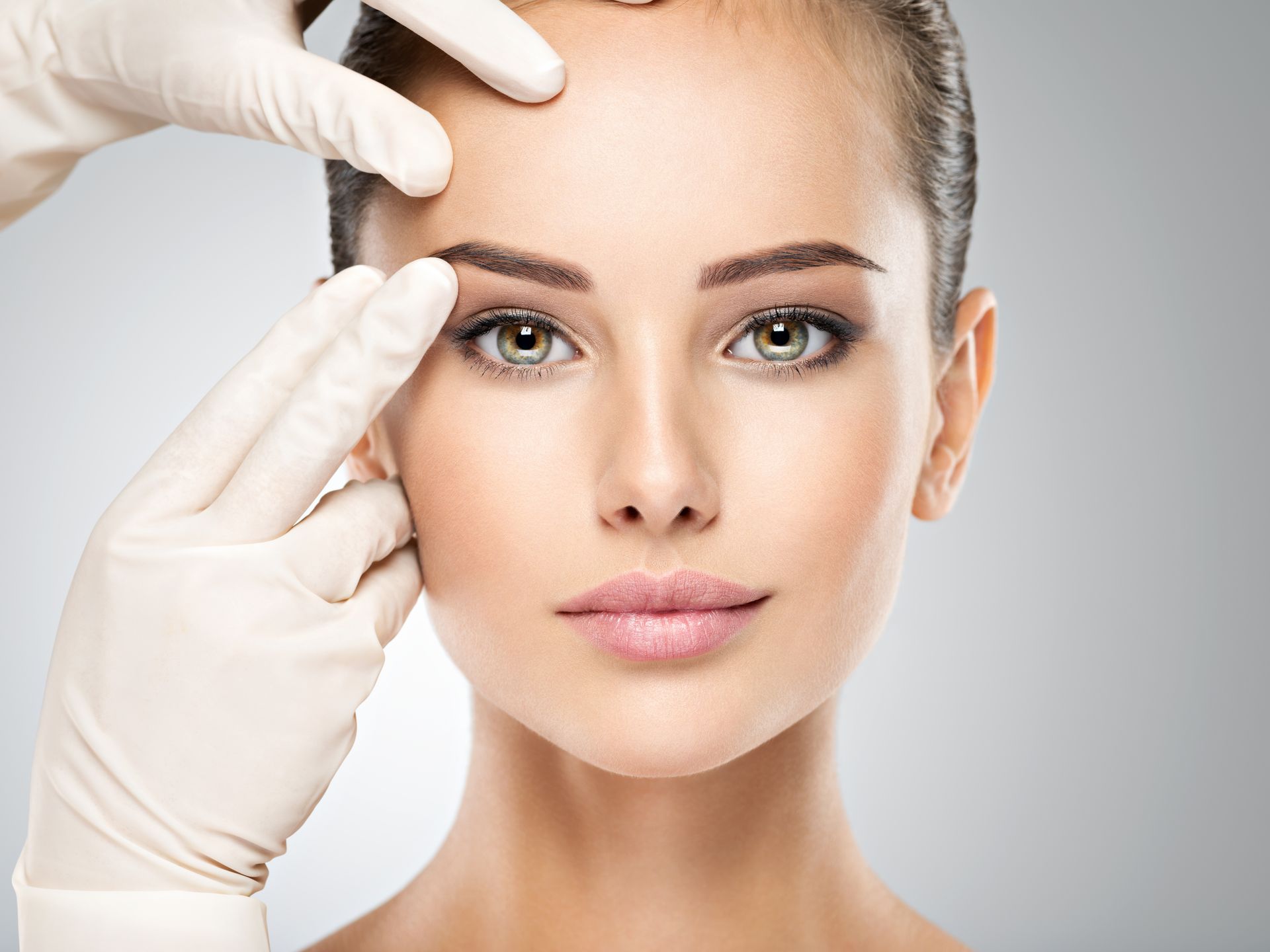 A stunning and confident woman with beautifully balanced facial features, a result of a facial harmo