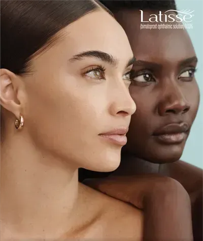 Two women are standing next to each other and looking at the camera.