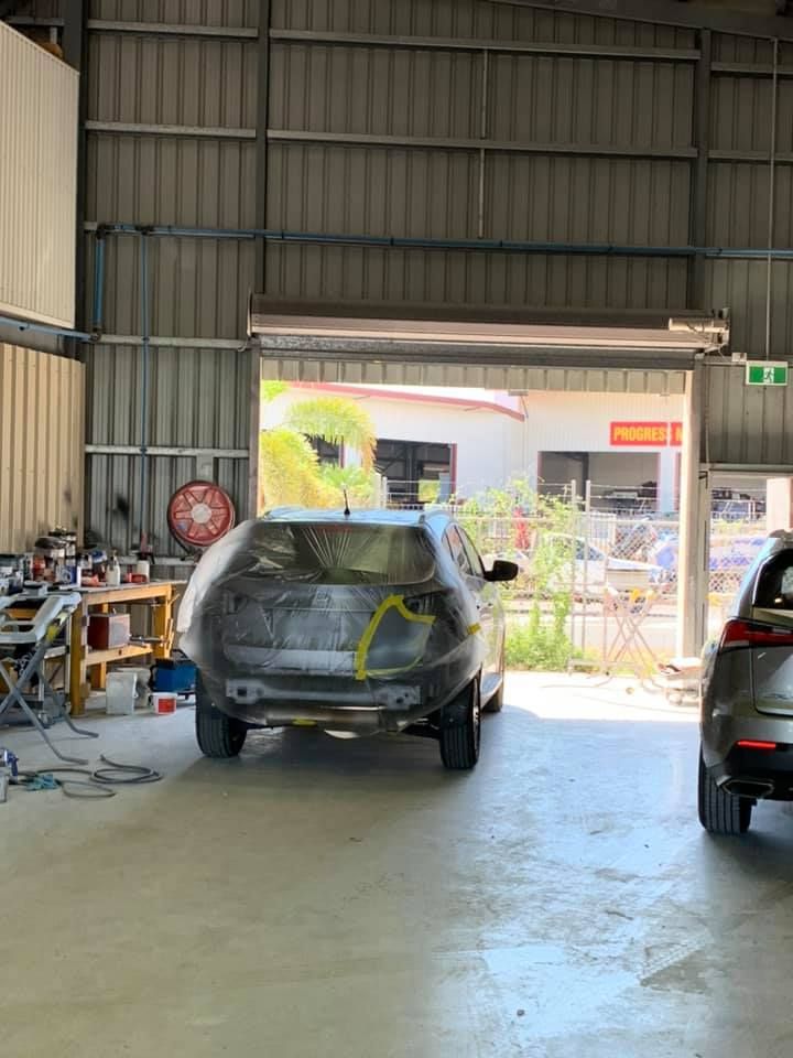 A Car is Parked in a Garage With the Door Open — Arafura Crash Repairs in Katherine, NT