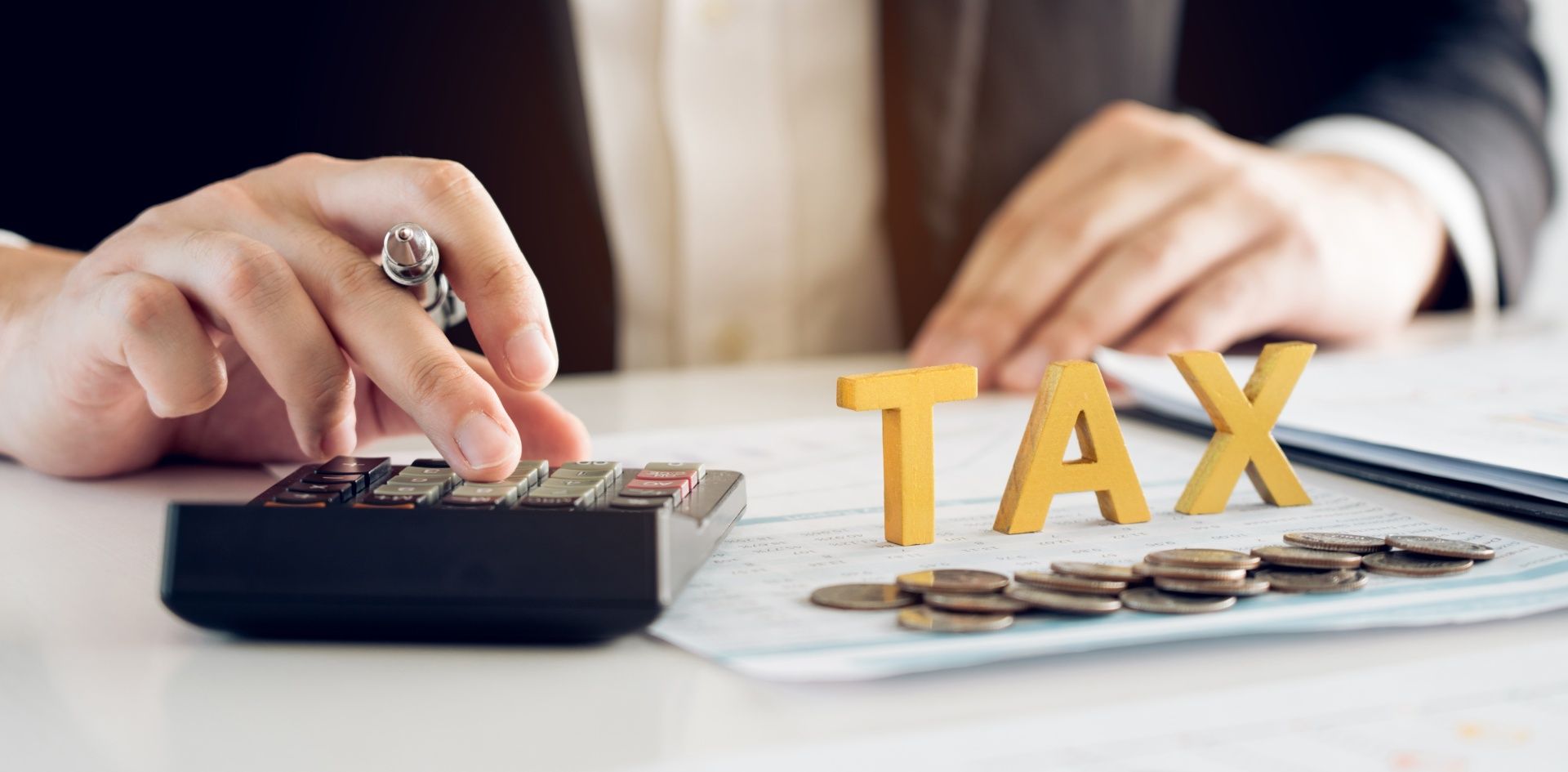 A person is using a calculator to calculate taxes.
