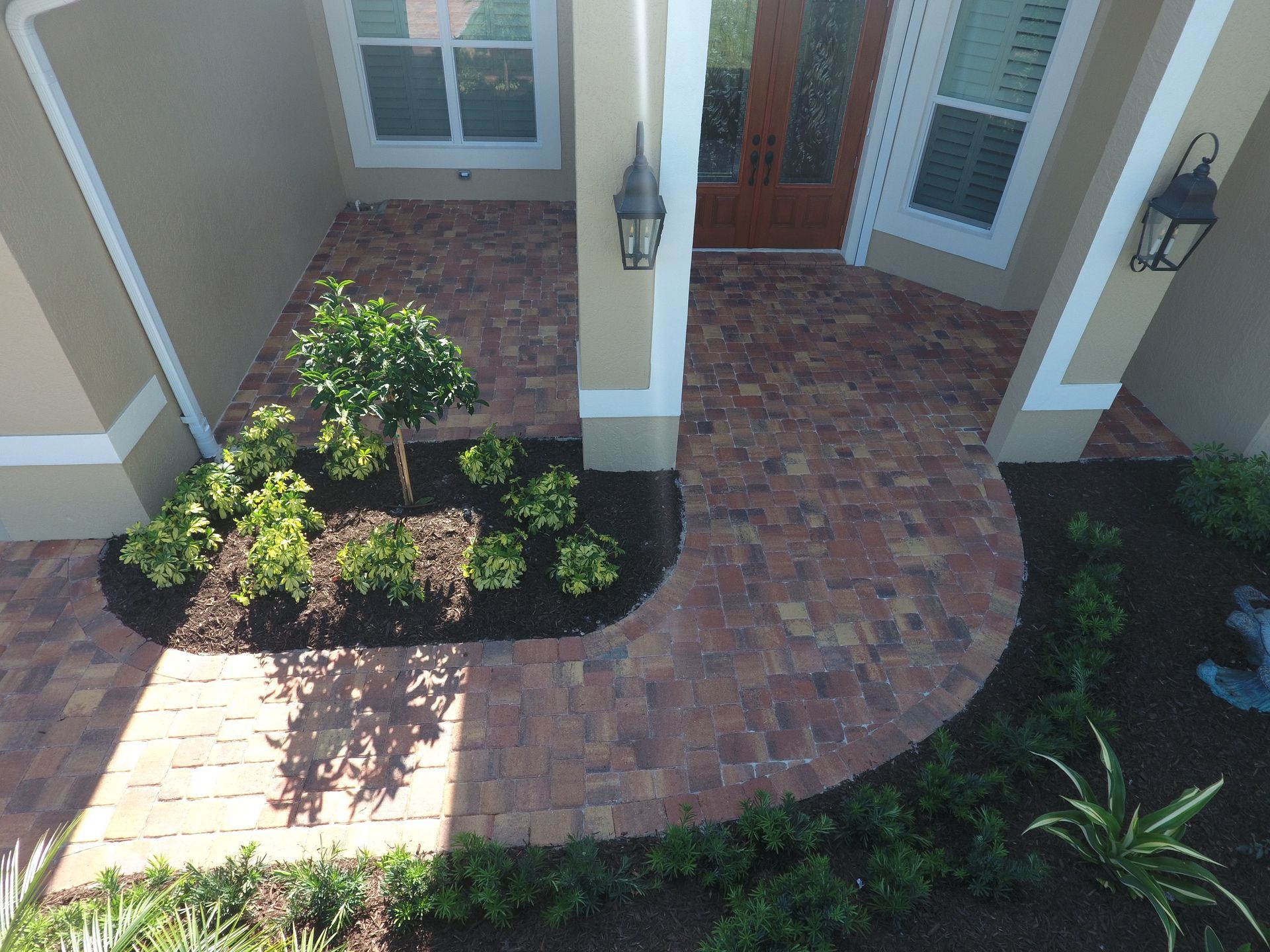 aerial view of brick paved front yard