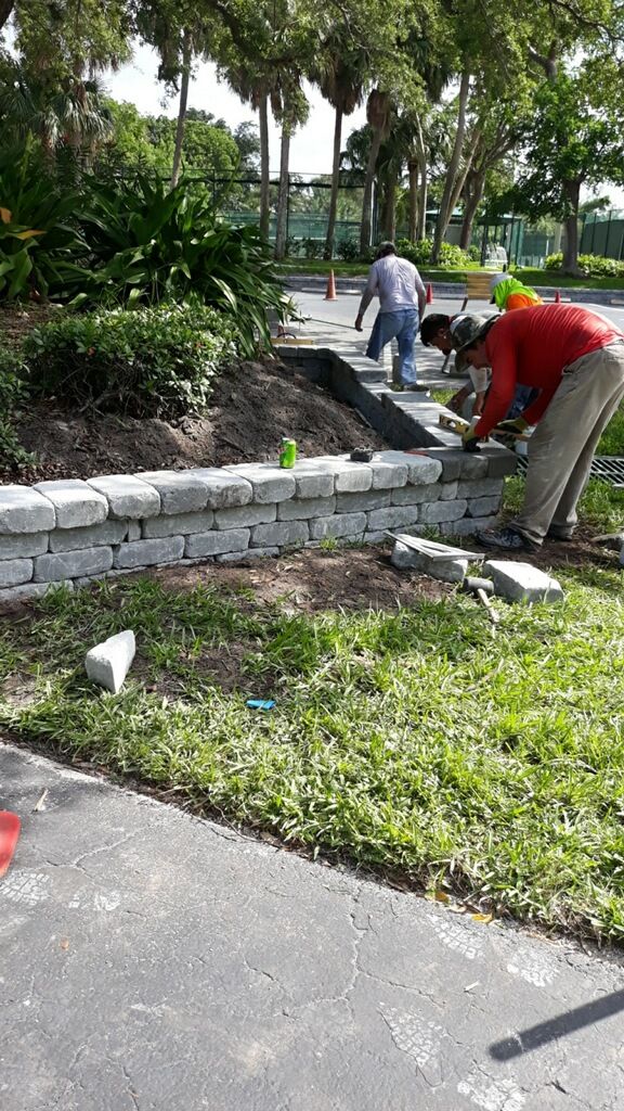 man laying stones for decorative retaining wall