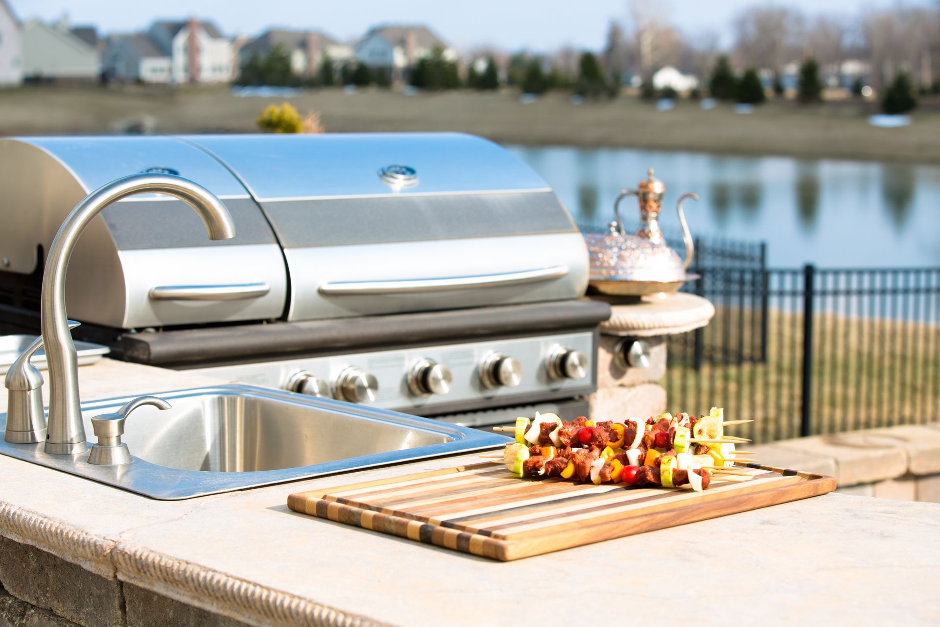 outdoor kitchen with barbeque on countertop