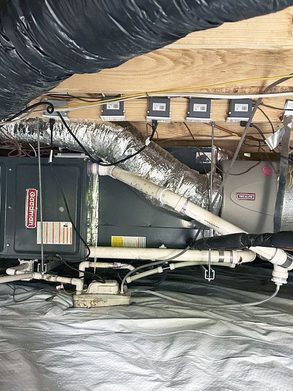 A picture of an air conditioner in a basement.