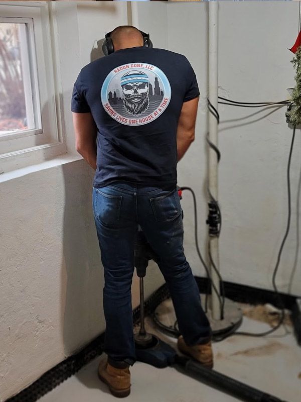 A man wearing a black shirt with a skull on it