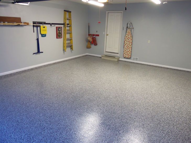 A garage with a ladder and an ironing board on the wall