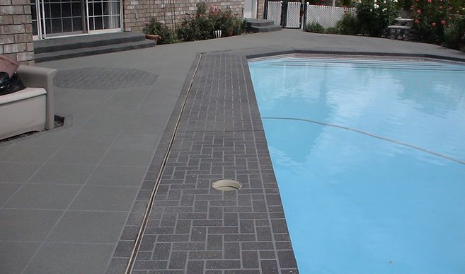 There is a swimming pool in the backyard of a house.