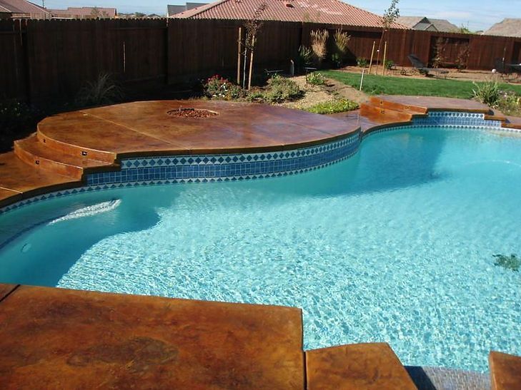 A large swimming pool with steps leading up to it