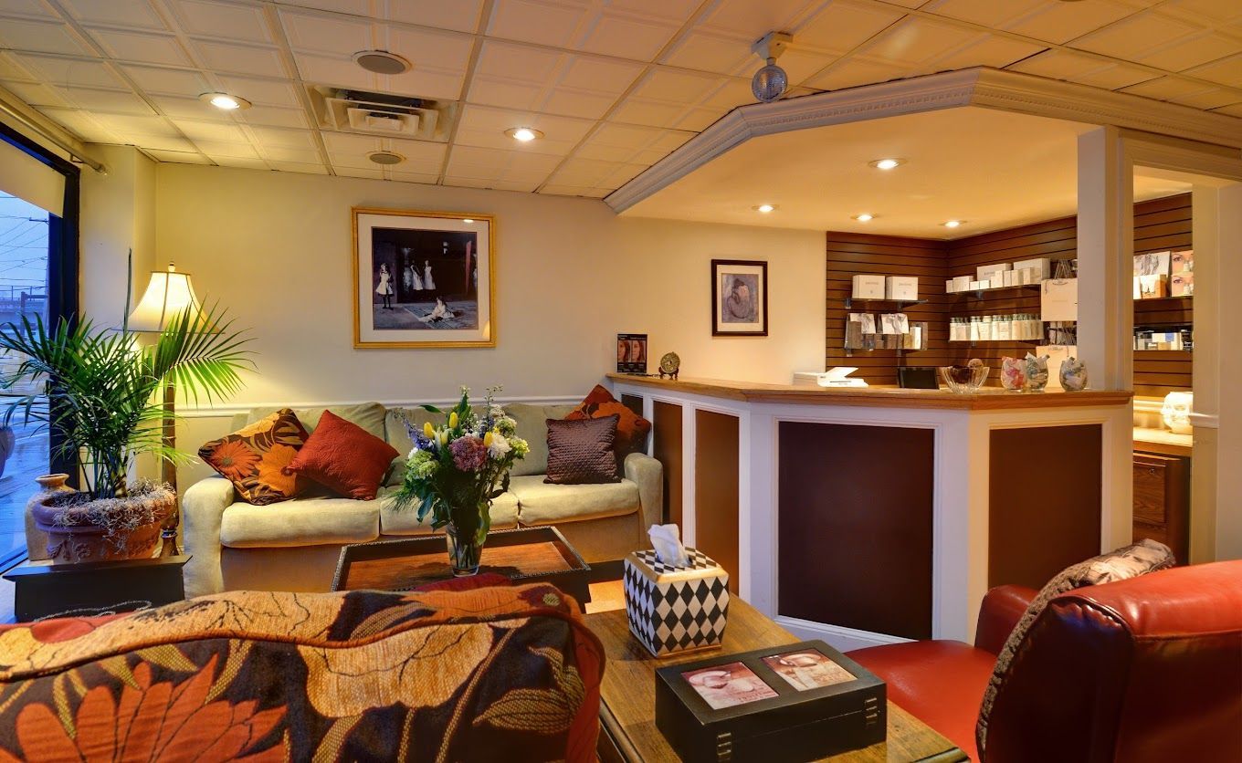 A living room with a couch and chairs and a counter