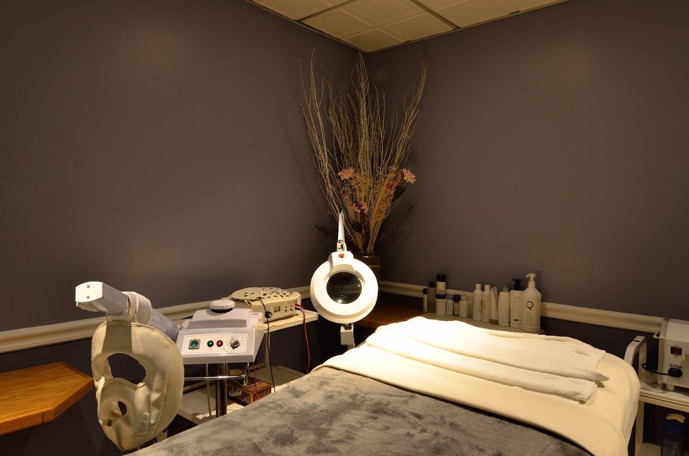 There is a massage table in the middle of the room.