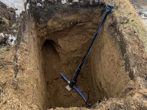 Man lying under a kitchen sink, fixing plumbing.